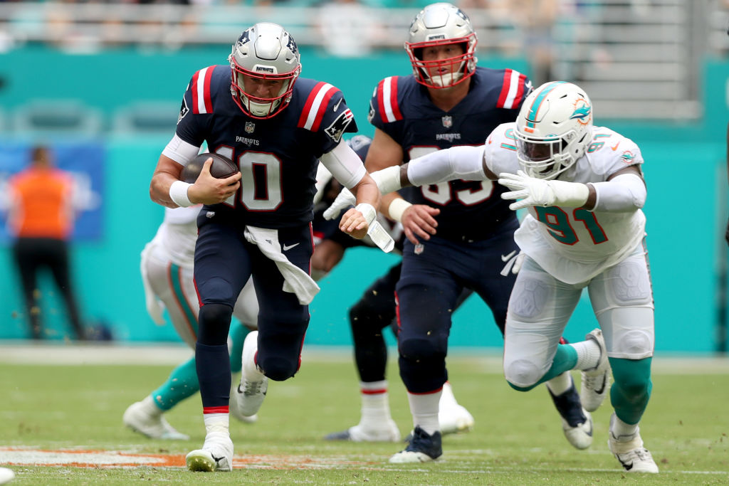 MIAMI GARDENS, FLORIDA - SEPTEMBER 11: Mac Jones #10 of the New England Patriots rushes during the first half against the Miami Dolphins at Hard Rock Stadium on September 11, 2022 in Miami Gardens, Florida. (Photo by Megan Briggs/Getty Images)