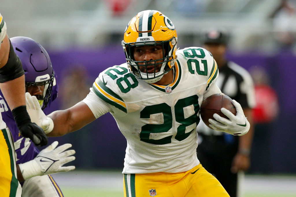 MINNEAPOLIS, MINNESOTA - SEPTEMBER 11: AJ Dillon #28 of the Green Bay Packers runs with the ball during the third quarter in the game against the Minnesota Vikings at U.S. Bank Stadium on September 11, 2022 in Minneapolis, Minnesota. (Photo by David Berding/Getty Images)