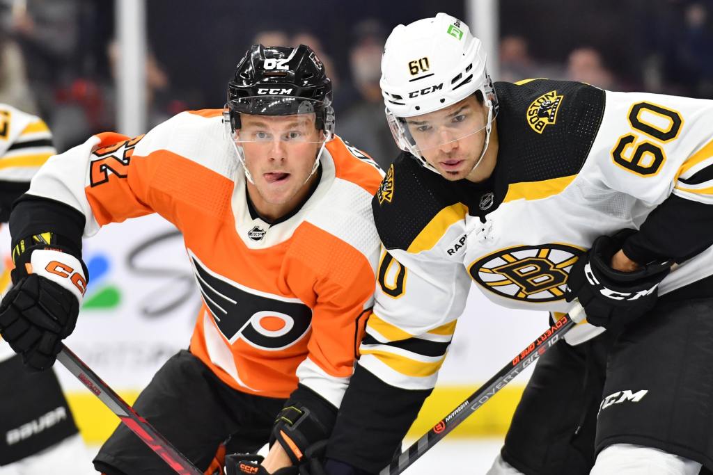 Sep 24, 2022; Philadelphia, Pennsylvania, USA; Philadelphia Flyers center Olle Lycksell (62) and Boston Bruins defenseman Kai Wissmann (60) battle for position during the second period at Wells Fargo Center. Mandatory Credit: Eric Hartline-USA TODAY Sports