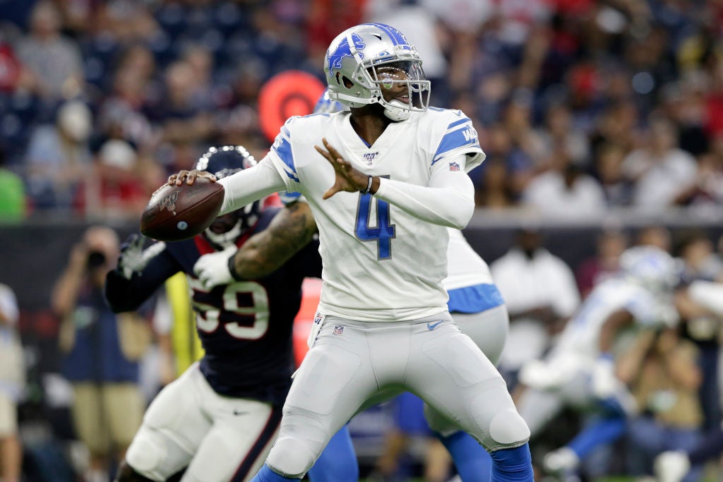 HOUSTON, TX - AUGUST 17: Josh Johnson #4 of the Detroit Lions looks to pass under pressure by Whitney Mercilus #59 of the Houston Texans in the first quarter during the preseason game at NRG Stadium on August 17, 2019 in Houston, Texas. (Photo by Tim Warner/Getty Images)