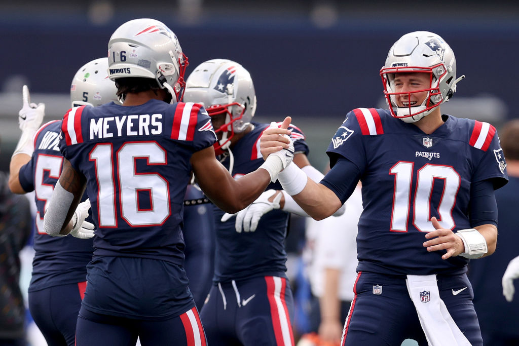 Mac Jones of the New England Patriots scrambles as DeForest Buckner News  Photo - Getty Images