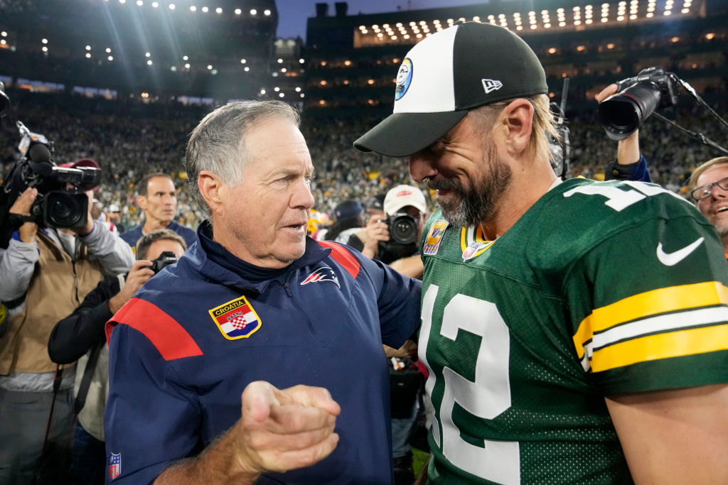 GREEN BAY, WISCONSIN - OCTOBER 02: Head coach Bill Belichick of the New England Patriots and Aaron Rodgers #12 of the Green Bay Packers talk after Green Bay's 27-24 win in overtime at Lambeau Field on October 02, 2022 in Green Bay, Wisconsin. (Photo by Patrick McDermott/Getty Images)