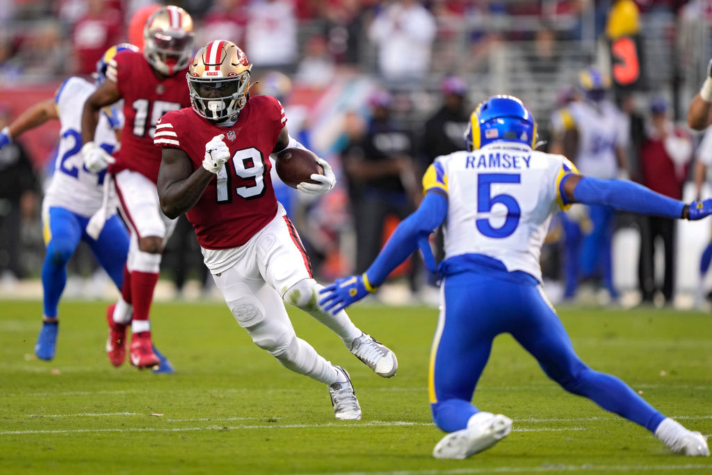 SANTA CLARA, CALIFORNIA - OCTOBER 03: Wide receiver Deebo Samuel #19 of the San Francisco 49ers rushes for a touchdown as he breaks a tackle by cornerback Jalen Ramsey #5 of the Los Angeles Rams during the second quarter at Levi's Stadium on October 03, 2022 in Santa Clara, California. (Photo by Thearon W. Henderson/Getty Images)