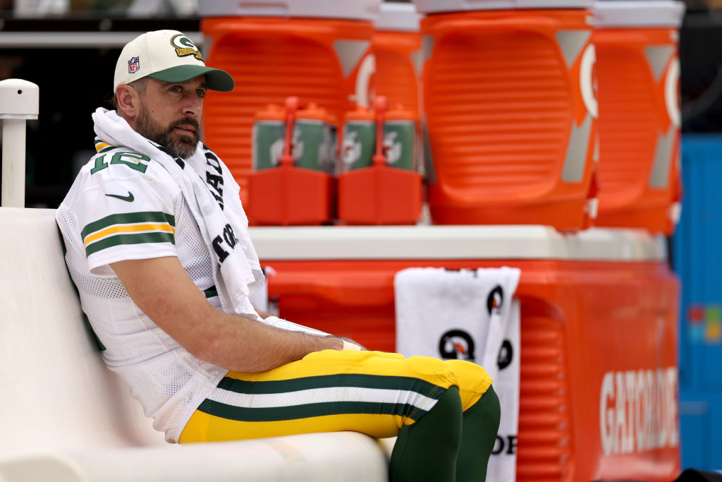 LANDOVER, MARYLAND - OCTOBER 23: Aaron Rodgers #12 of the Green Bay Packers looks on from the bench during the third quarter of the game against the Washington Commanders at FedExField on October 23, 2022 in Landover, Maryland. (Photo by Scott Taetsch/Getty Images)