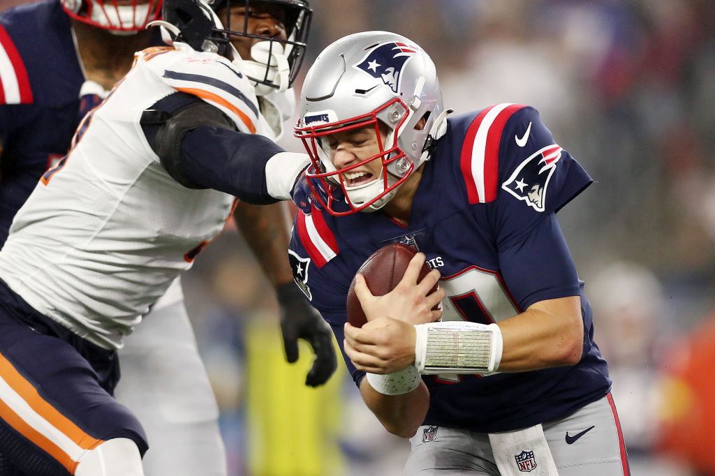 FOXBOROUGH, MASSACHUSETTS - OCTOBER 24: Mac Jones #10 of the New England Patriots runs with the ball during the first quarter against the Chicago Bears at Gillette Stadium on October 24, 2022 in Foxborough, Massachusetts. (Photo by Adam Glanzman/Getty Images)