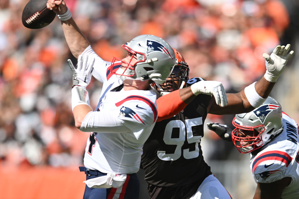 CLEVELAND, OHIO - OCTOBER 16: Bailey Zappe #4 of the New England Patriots fumbles the ball while being hit by Myles Garrett #95 of the Cleveland Browns during the first quarter at FirstEnergy Stadium on October 16, 2022 in Cleveland, Ohio. (Photo by Nick Cammett/Getty Images)