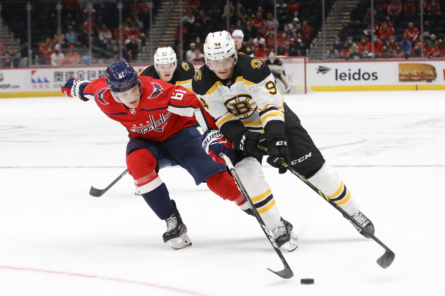 Sep 26, 2021; Washington, District of Columbia, USA; Boston Bruins center Jakub Lauko (94) skates with the puck as Washington Capitals defenseman Martin Has (61) defends during the first period at Capital One Arena. Mandatory Credit: Geoff Burke-USA TODAY Sports