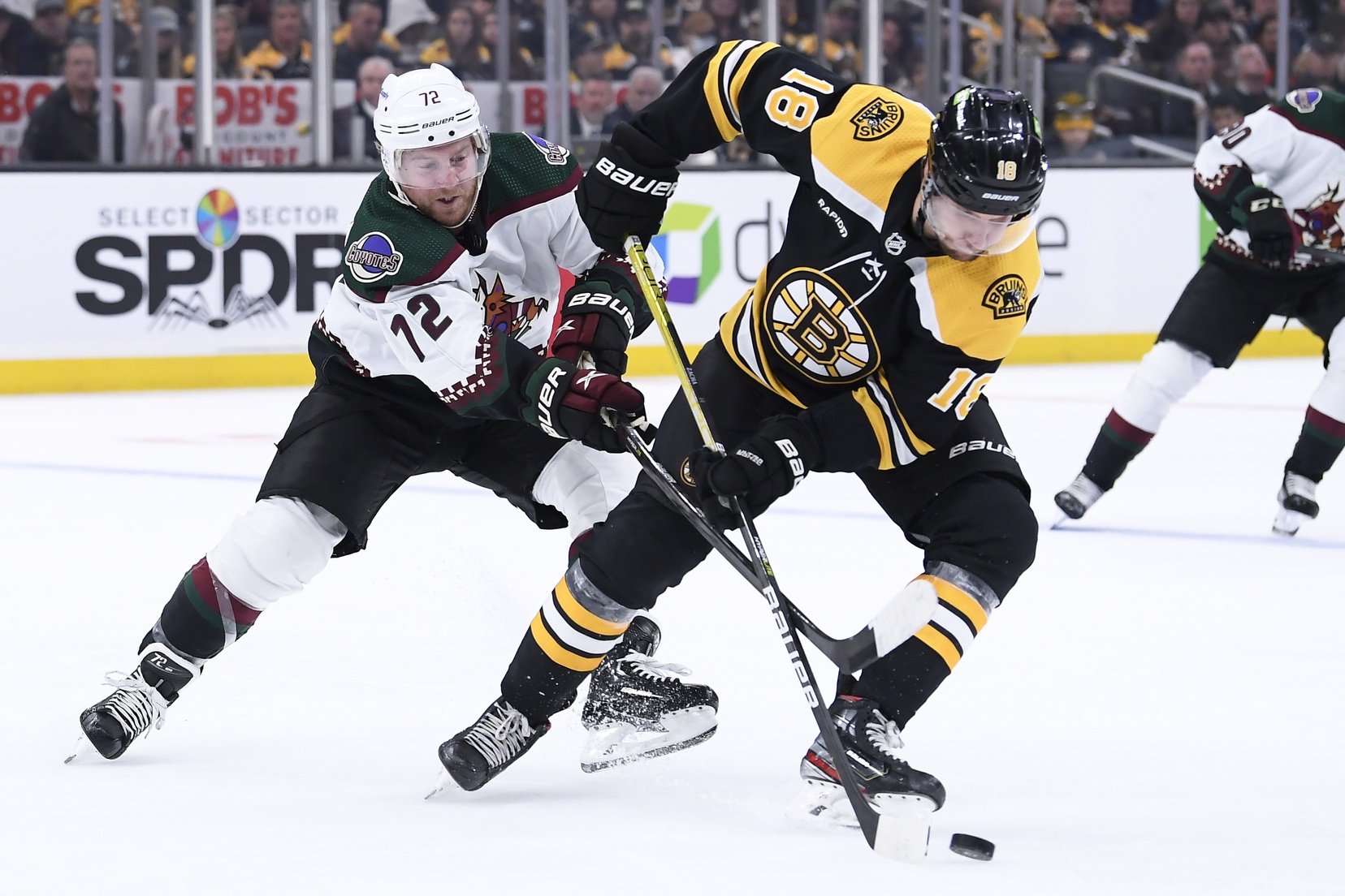 Oct 15, 2022; Boston, Massachusetts, USA;  Boston Bruins center Pavel Zacha (18) controls the puck from Arizona Coyotes center Travis Boyd (72) during the second period at TD Garden. Mandatory Credit: Bob DeChiara-USA TODAY Sports