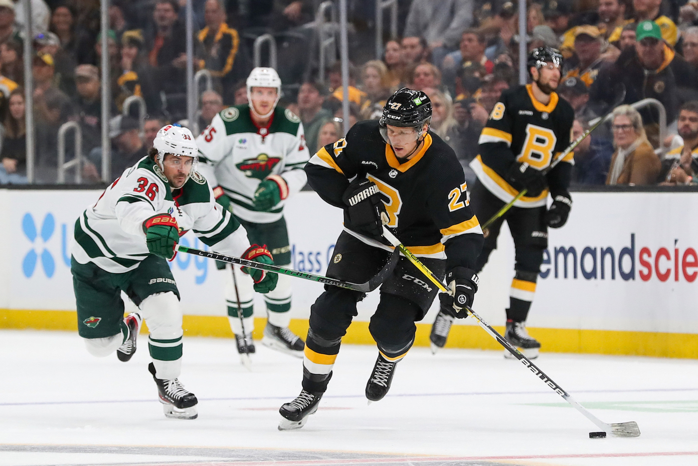 Oct 22, 2022; Boston, Massachusetts, USA; Minnesota Wild right wing Mats Zuccarello (36) defends Boston Bruins defenseman Hampus Lindholm (27) during the second period at TD Garden. Mandatory Credit: Paul Rutherford-USA TODAY Sports
