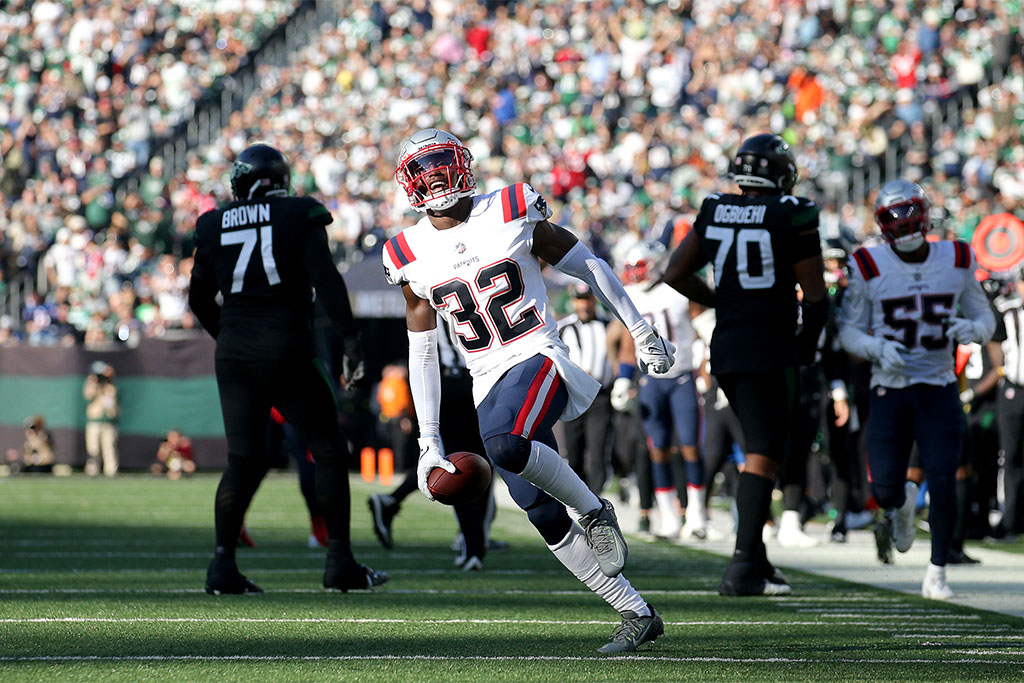 Oct 30, 2022; East Rutherford, New Jersey, USA; New England Patriots safety Devin McCourty (32) reacts after intercepting a pass during the fourth quarter against the New York Jets at MetLife Stadium. Mandatory Credit: Brad Penner-USA TODAY Sports