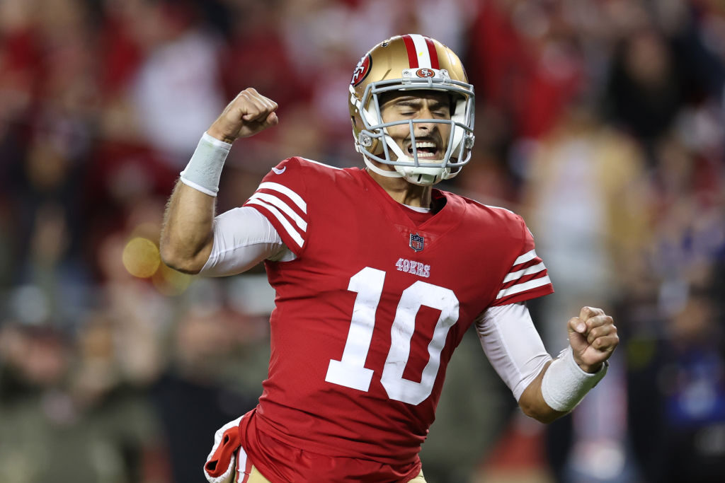 SANTA CLARA, CALIFORNIA - NOVEMBER 13: Jimmy Garoppolo #10 of the San Francisco 49ers celebrates after a touchdown by Christian McCaffrey #23 during the fourth quarter against the Los Angeles Chargers at Levi's Stadium on November 13, 2022 in Santa Clara, California. (Photo by Ezra Shaw/Getty Images)