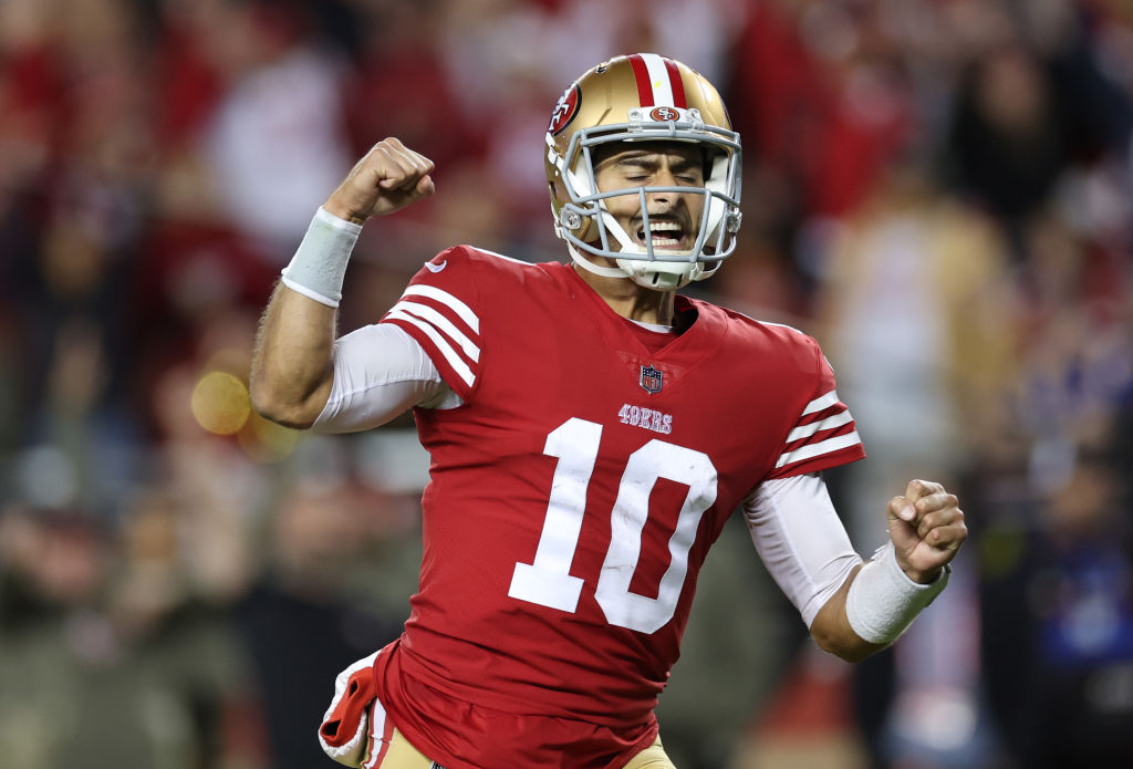 SANTA CLARA, CALIFORNIA - NOVEMBER 13: Jimmy Garoppolo #10 of the San Francisco 49ers celebrates after a touchdown by Christian McCaffrey #23 during the fourth quarter against the Los Angeles Chargers at Levi's Stadium on November 13, 2022 in Santa Clara, California. (Photo by Ezra Shaw/Getty Images)