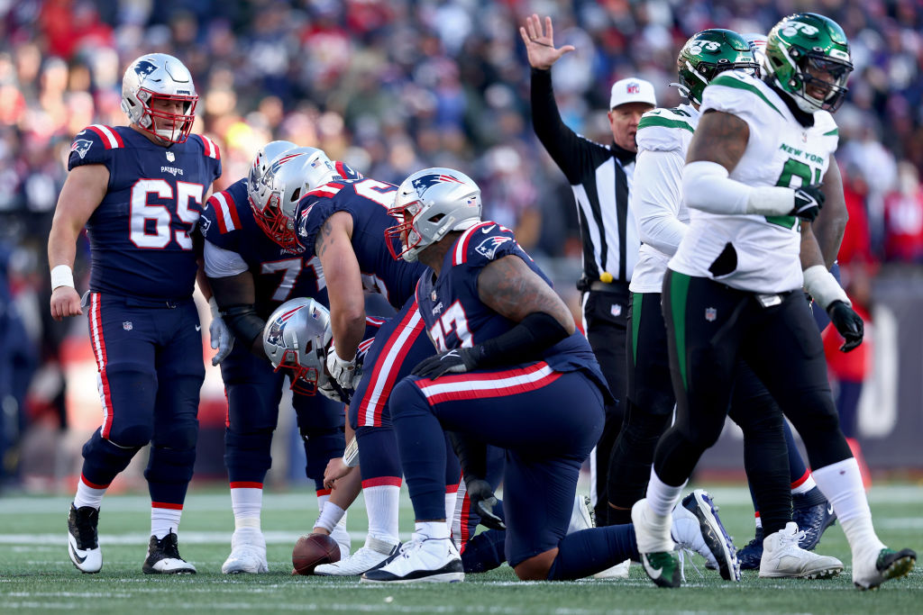 FOXBOROUGH, MASSACHUSETTS - NOVEMBER 20: Mac Jones #10 of the New England Patriots is helped up after getting sacked during the second quarter against the New York Jets at Gillette Stadium on November 20, 2022 in Foxborough, Massachusetts. (Photo by Adam Glanzman/Getty Images)