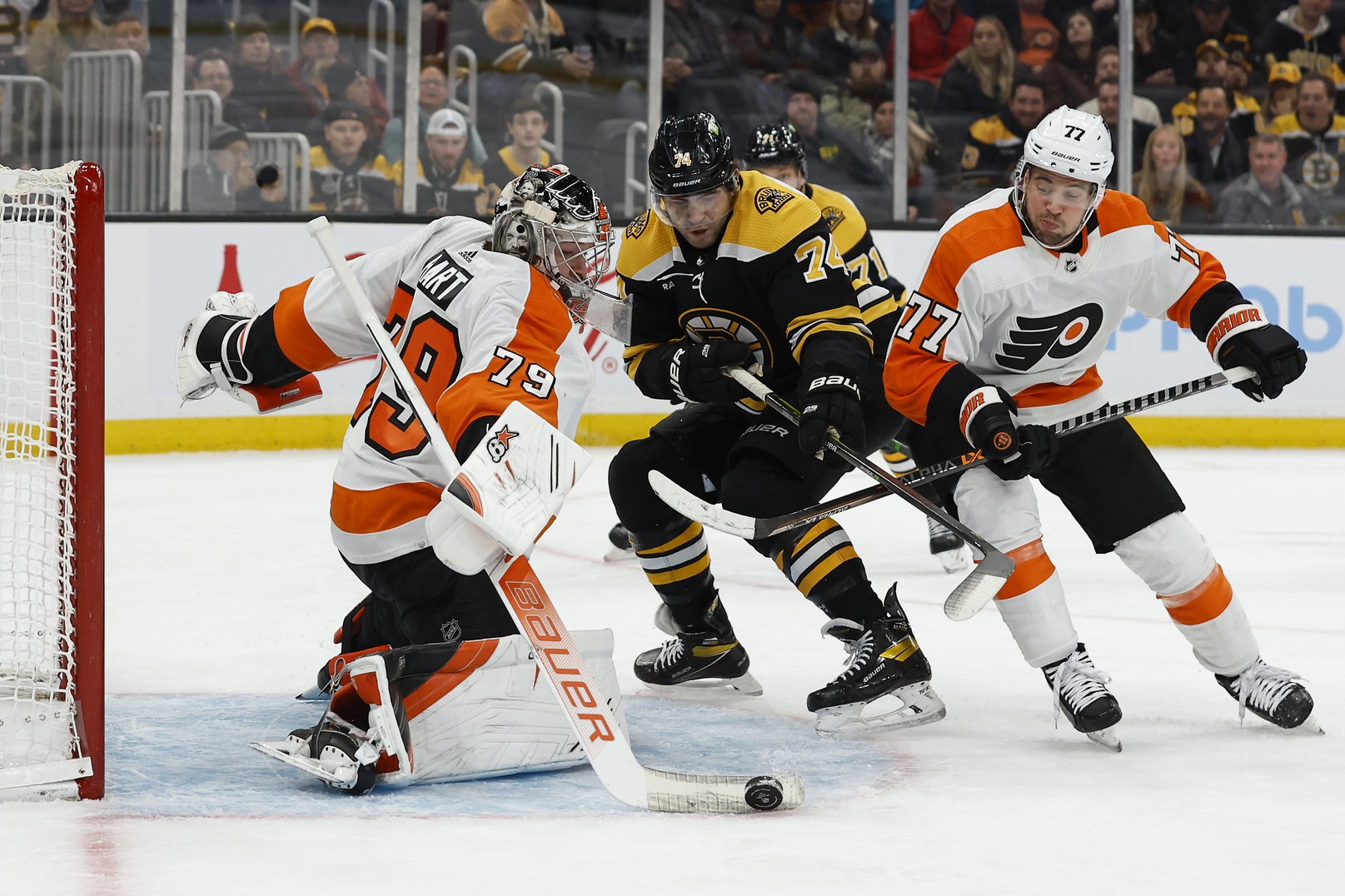 Nov 17, 2022; Boston, Massachusetts, USA; Philadelphia Flyers goaltender Carter Hart (79) makes a stick save as defenseman Tony DeAngelo (77) tries to keep Boston Bruins left wing Jake DeBrusk (74) from the rebound during the first period at TD Garden. Mandatory Credit: Winslow Townson/USA TODAY Sports