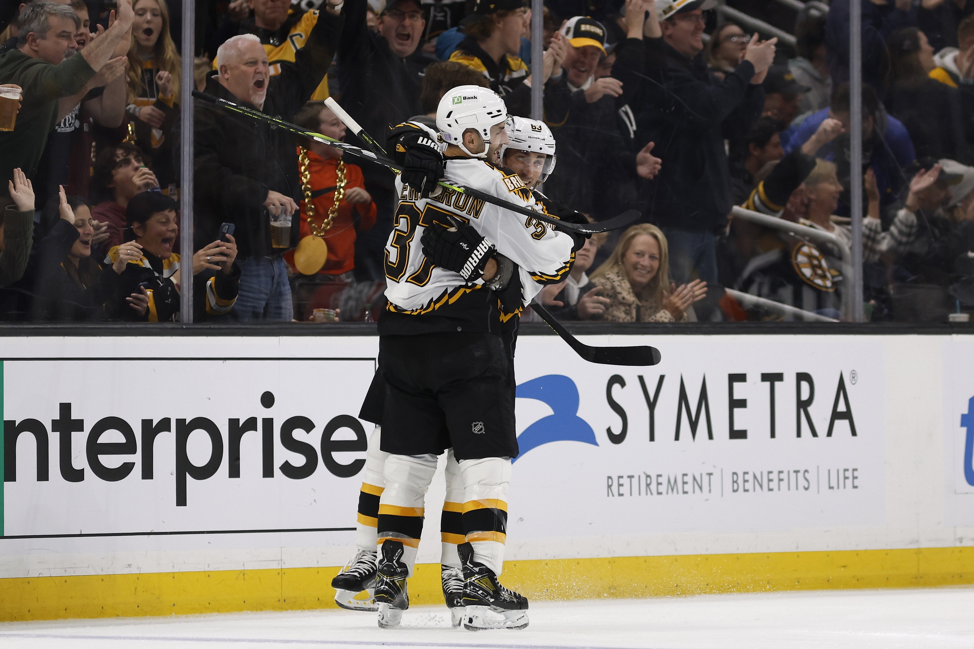 Nov 19, 2022; Boston, Massachusetts, USA; Boston Bruins center Patrice Bergeron (37) gets a hug from left wing Brad Marchand (63) after he scored against the Chicago Blackhawks during the second period at TD Garden. Mandatory Credit: Winslow Townson/USA TODAY Sports