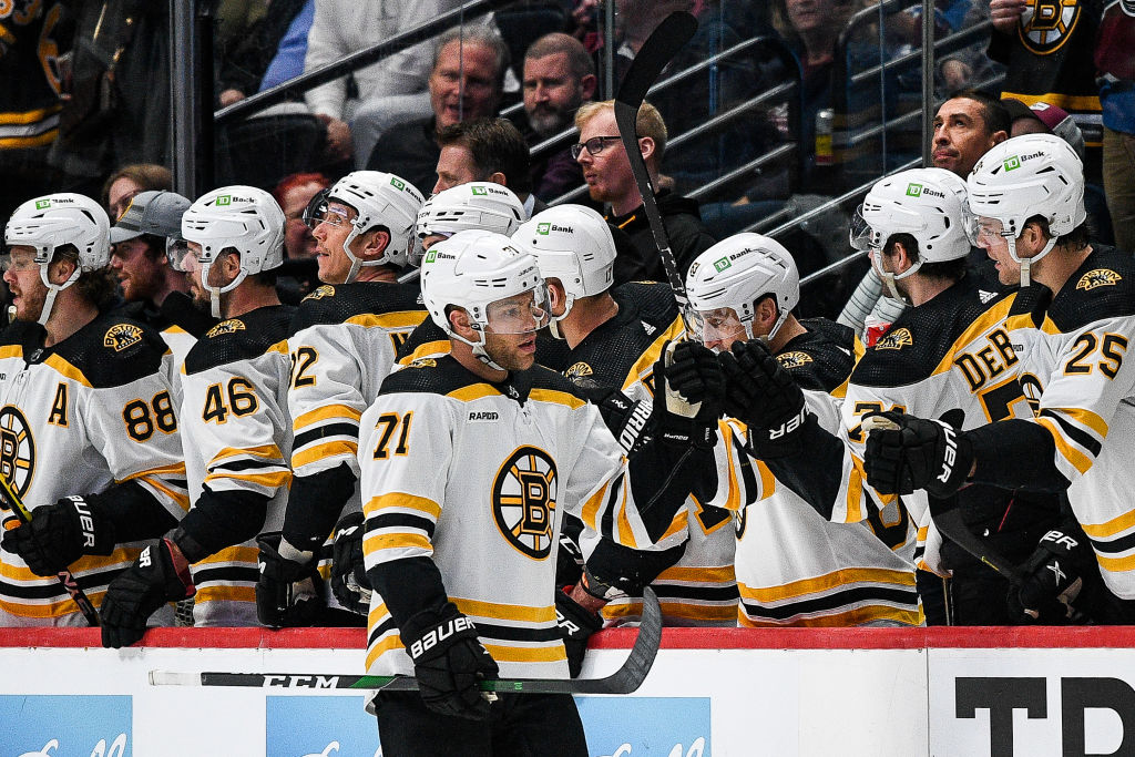 DENVER, COLORADO - DECEMBER 7:  Taylor Hall #71 of the Boston Bruins celebrates with players on the bench after scoring a second period goal against the Colorado Avalanche at Ball Arena on December 7, 2022 in Denver, Colorado. (Photo by Dustin Bradford/Getty Images)