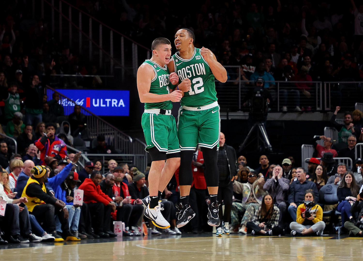 ATLANTA, GEORGIA - NOVEMBER 16: Payton Pritchard #11 of the Boston Celtics reacts with Grant Williams #12 after hitting a three-point basket as time expires in the second quarter against the Atlanta Hawks with at State Farm Arena on November 16, 2022 in Atlanta, Georgia. NOTE TO USER: User expressly acknowledges and agrees that, by downloading and or using this photograph, User is consenting to the terms and conditions of the Getty Images License Agreement. (Photo by Kevin C. Cox/Getty Images)