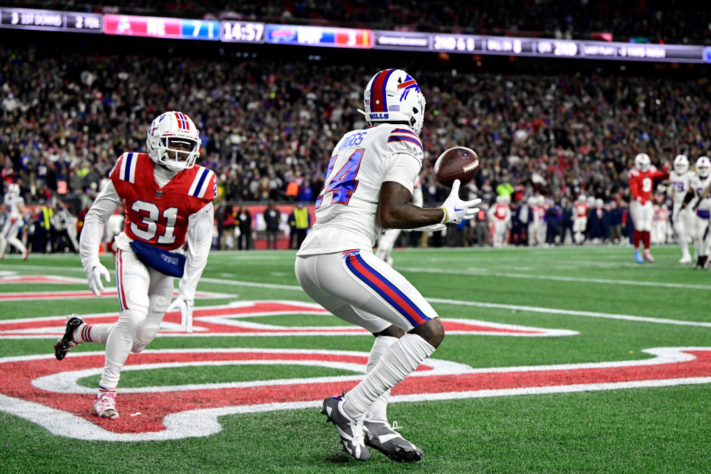 FOXBOROUGH, MASSACHUSETTS - DECEMBER 01: Wide receiver Stefon Diggs #14 of the Buffalo Bills catches a first half touchdown pass in front of cornerback Jonathan Jones #31 of the New England Patriots at Gillette Stadium on December 01, 2022 in Foxborough, Massachusetts. (Photo by Billie Weiss/Getty Images)