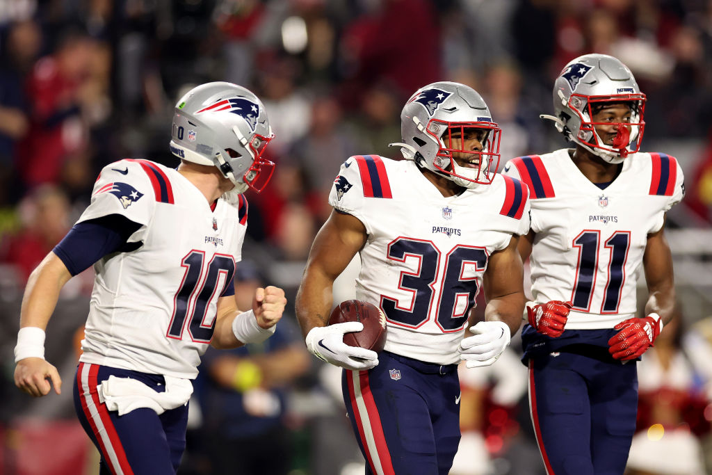 GLENDALE, ARIZONA - DECEMBER 12: Kevin Harris #36 of the New England Patriots celebrates with Mac Jones #10 and Tyquan Thornton #11 after scoring a 14 yard touchdown against the Arizona Cardinals during the second quarter of the game at State Farm Stadium on December 12, 2022 in Glendale, Arizona. (Photo by Christian Petersen/Getty Images)