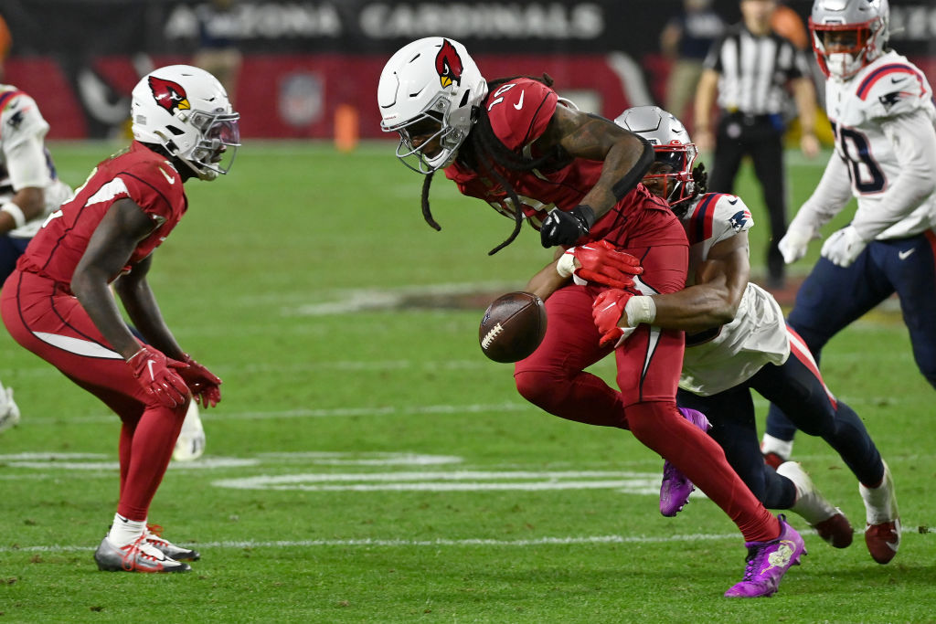 GLENDALE, ARIZONA - DECEMBER 12: DeAndre Hopkins #10 of the Arizona Cardinals fumbles the ball against the New England Patriots during the third quarter of the game at State Farm Stadium on December 12, 2022 in Glendale, Arizona. (Photo by Norm Hall/Getty Images)