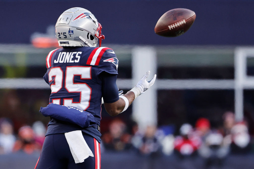 FOXBOROUGH, MASSACHUSETTS - DECEMBER 24: Marcus Jones #25 of the New England Patriots returns an interception for a touchdown during the third quarter against the Cincinnati Bengals at Gillette Stadium on December 24, 2022 in Foxborough, Massachusetts. (Photo by Winslow Townson/Getty Images)