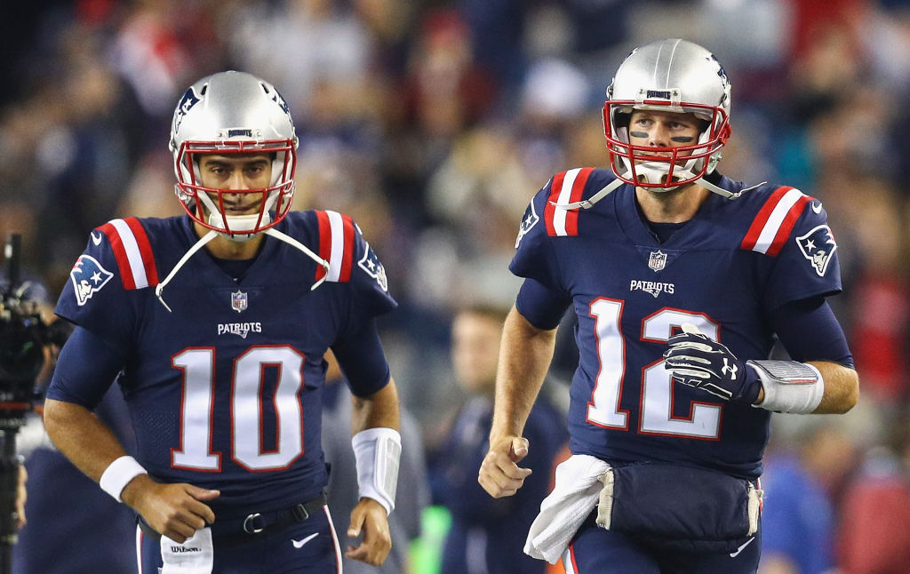 FOXBORO, MA - OCTOBER 22:  Tom Brady #12 and Jimmy Garoppolo #10 of the New England Patriots run onto the field before a game against the Atlanta Falcons at Gillette Stadium on October 22, 2017 in Foxboro, Massachusetts.  (Photo by Maddie Meyer/Getty Images)