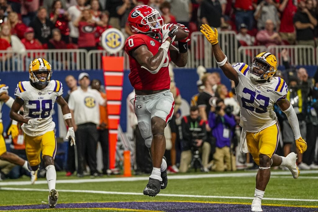 Dec 3, 2022; Atlanta, GA, USA; Georgia Bulldogs tight end Darnell Washington (0) catches a touchdown pass behind LSU Tigers linebacker Micah Baskerville (23) during the first half during the SEC Championship game at Mercedes-Benz Stadium. Credit: Dale Zanine-USA TODAY Sports