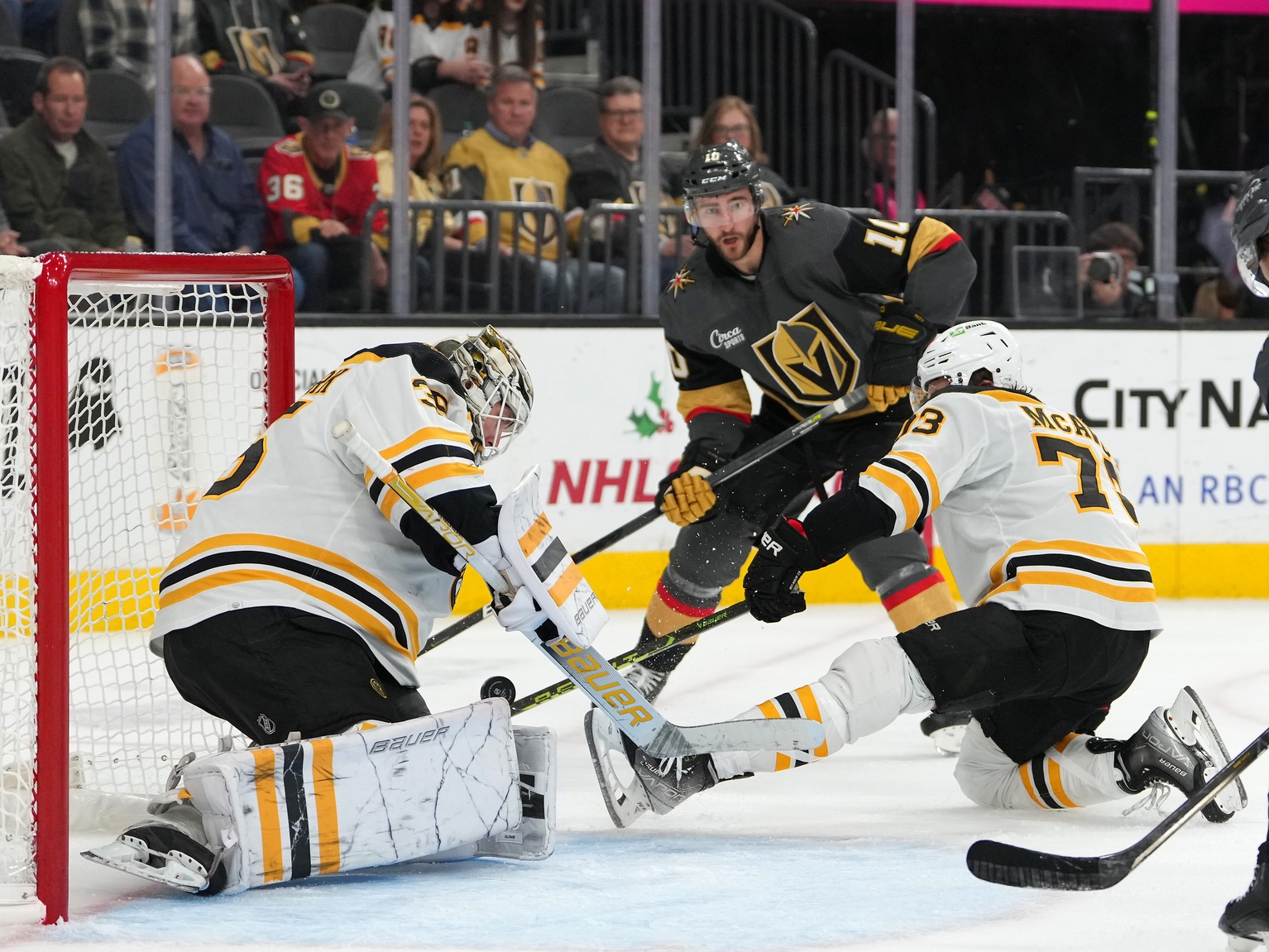Dec 11, 2022; Las Vegas, Nevada, USA; Boston Bruins defenseman Charlie McAvoy (73) deflects a centering pass from Vegas Golden Knights center Nicolas Roy (10) as Boston Bruins goaltender Linus Ullmark (35) defends his net during the second period at T-Mobile Arena. Mandatory Credit: Stephen R. Sylvanie/USA TODAY Sports