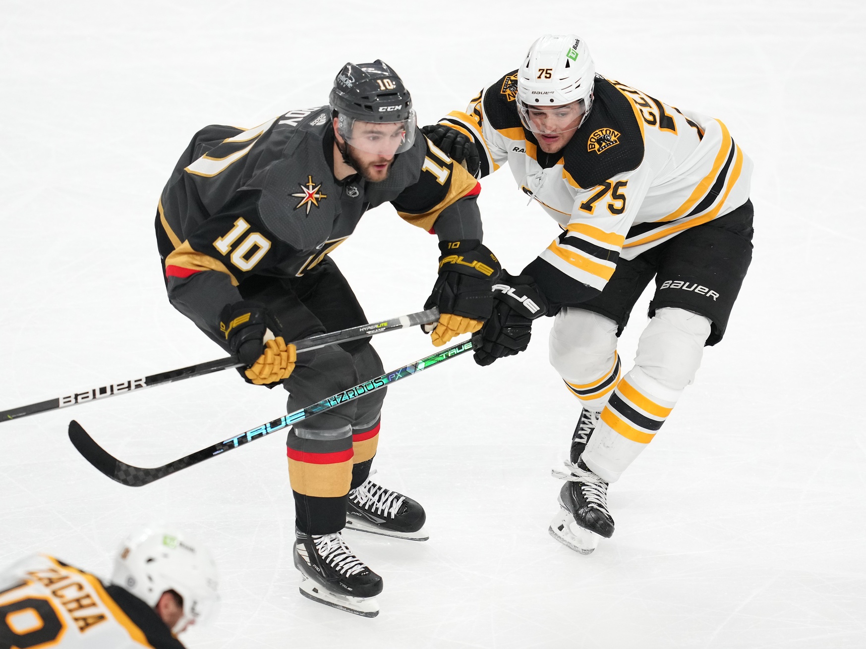 Dec 11, 2022; Las Vegas, Nevada, USA; Boston Bruins defenseman Connor Clifton (75) covers Vegas Golden Knights center Nicolas Roy (10) during the third period at T-Mobile Arena. Mandatory Credit: Stephen R. Sylvanie/USA TODAY Sports