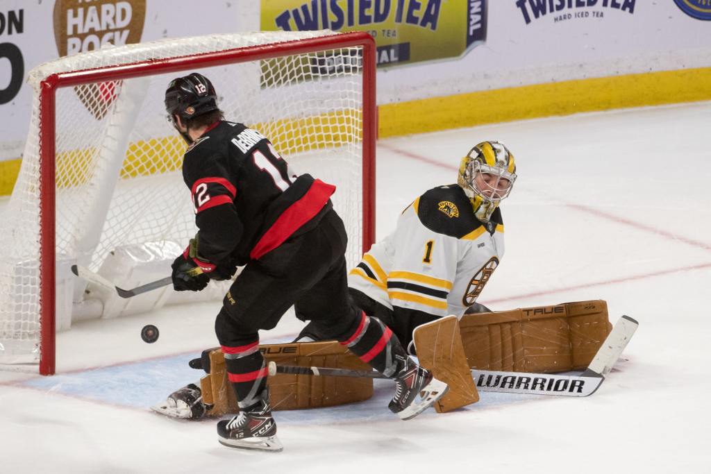 Dec 27, 2022; Ottawa, Ontario, CAN; Ottawa Senators right wing Alex DeBrincat (12) scores the winning goal against Boston Bruins goalie Jeremy Swayman (1) in a shootout at the Canadian Tire Centre. Mandatory Credit: Marc DesRosiers/USA TODAY Sports