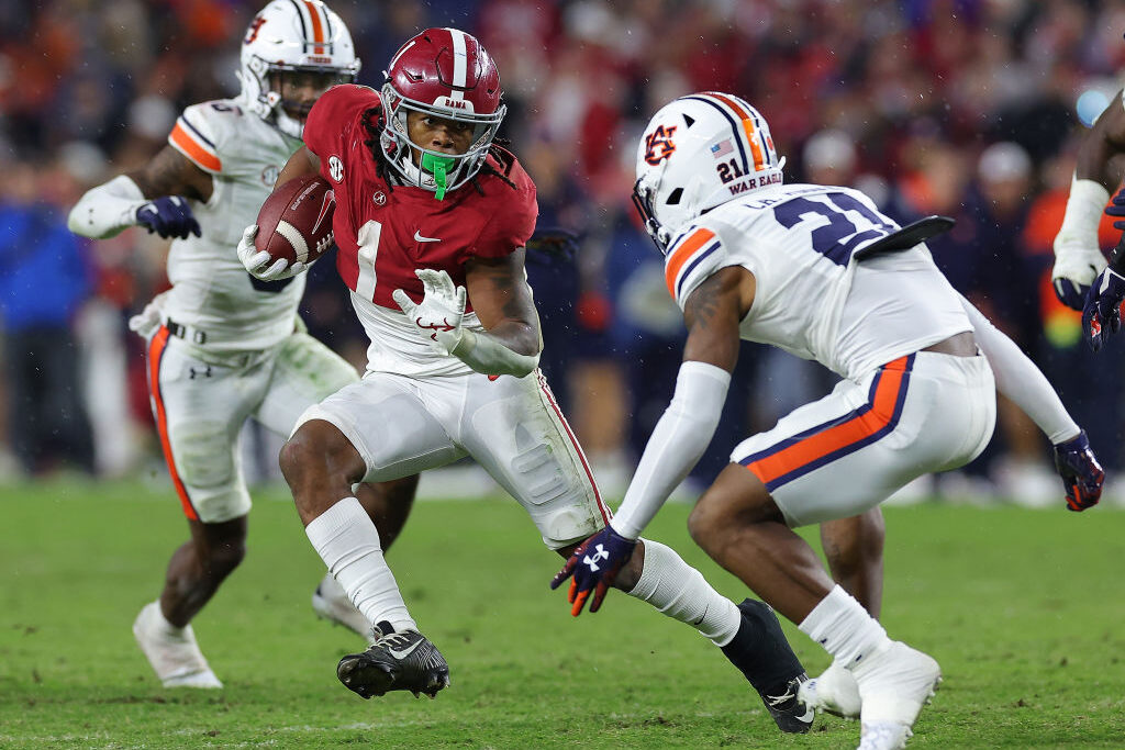 TUSCALOOSA, ALABAMA - NOVEMBER 26: Jahmyr Gibbs #1 of the Alabama Crimson Tide rushes against Caleb Wooden #21 of the Auburn Tigers during the second half at Bryant-Denny Stadium on November 26, 2022 in Tuscaloosa, Alabama. (Photo by Kevin C. Cox/Getty Images)