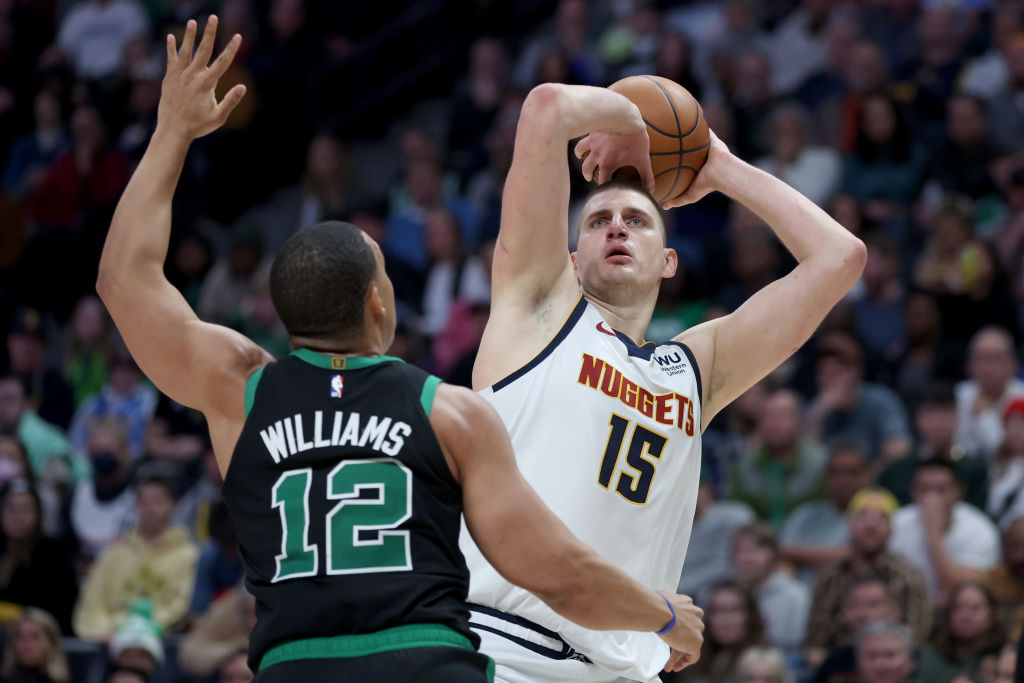 DENVER, COLORADO - JANUARY 01: Nikola Jokic #15 of the Denver Nuggets puts up a shot against Grant Williams #12 of the Boston Celtics during the fourth quarter at Ball Arena on January 01, 2023 in Denver, Colorado. NOTE TO USER: User expressly acknowledges and agrees that, by downloading and/or using this photograph, User is consenting to the terms and conditions of the Getty Images License Agreement. (Photo by Matthew Stockman/Getty Images)