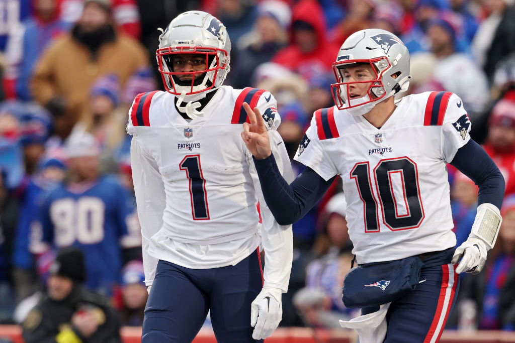 ORCHARD PARK, NEW YORK - JANUARY 08: DeVante Parker #1 of the New England Patriots and Mac Jones #10 of the New England Patriots celebrate after Parker's touchdown reception during the fourth quarter against the Buffalo Bills at Highmark Stadium on January 08, 2023 in Orchard Park, New York. (Photo by Bryan M. Bennett/Getty Images)