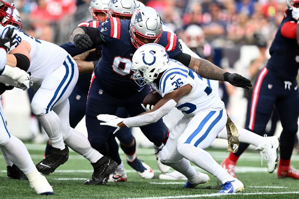 Nov 6, 2022; Foxborough, Massachusetts, USA; New England Patriots defensive tackle Davon Godchaux (92) tackles Indianapolis Colts running back Deon Jackson (35) during the first half at Gillette Stadium. Credit: Brian Fluharty-USA TODAY Sports