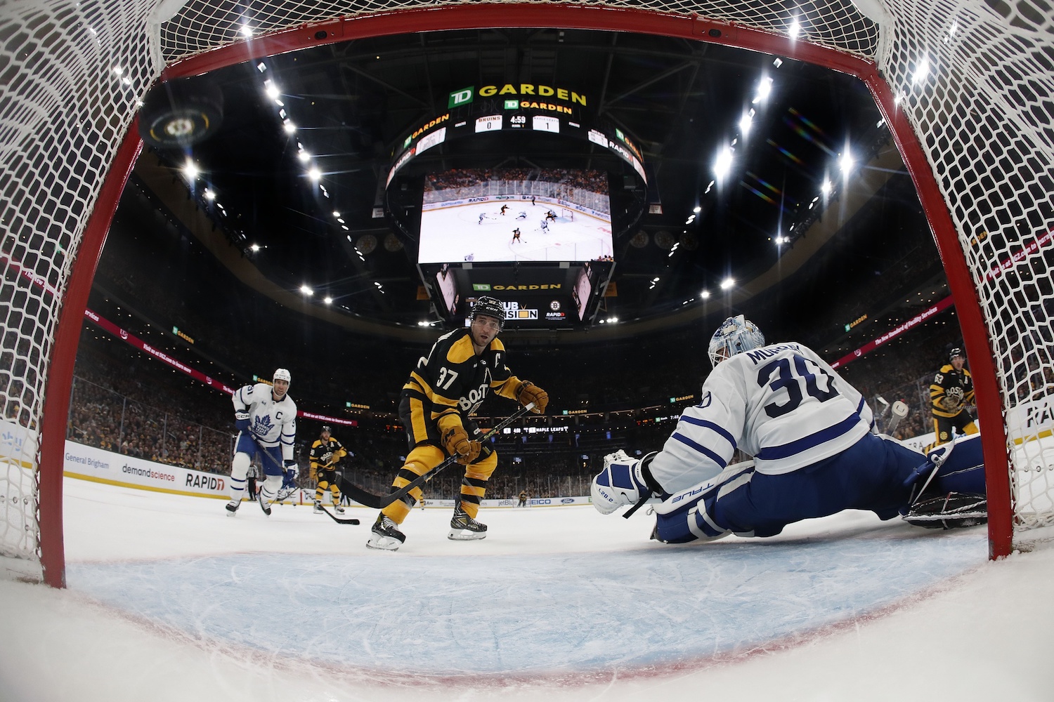 Jan 14, 2023; Boston, Massachusetts, USA; Boston Bruins center Patrice Bergeron (37) deflects a pass past Toronto Maple Leafs goaltender Matt Murray (30) for a goal during the first period at TD Garden. Mandatory Credit: Winslow Townson/USA TODAY Sports