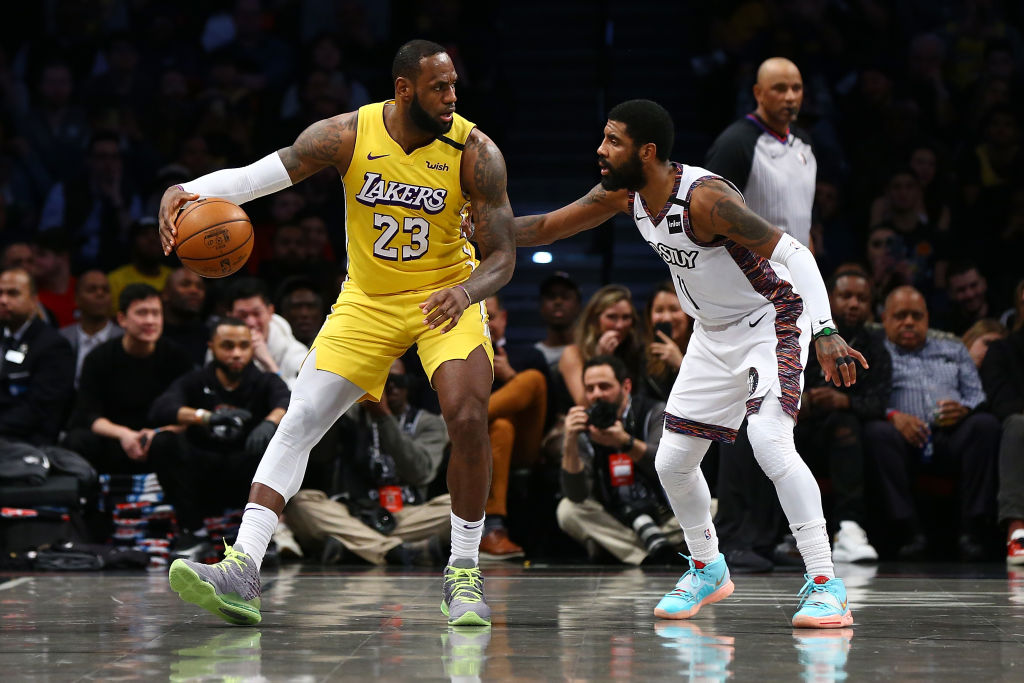 NEW YORK, NEW YORK - JANUARY 23: LeBron James #23 of the Los Angeles Lakers posts up against Kyrie Irving #11 of the Brooklyn Nets at Barclays Center on January 23, 2020 in New York City. NOTE TO USER: User expressly acknowledges and agrees that, by downloading and or using this photograph, User is consenting to the terms and conditions of the Getty Images License Agreement. (Photo by Mike Stobe/Getty Images)