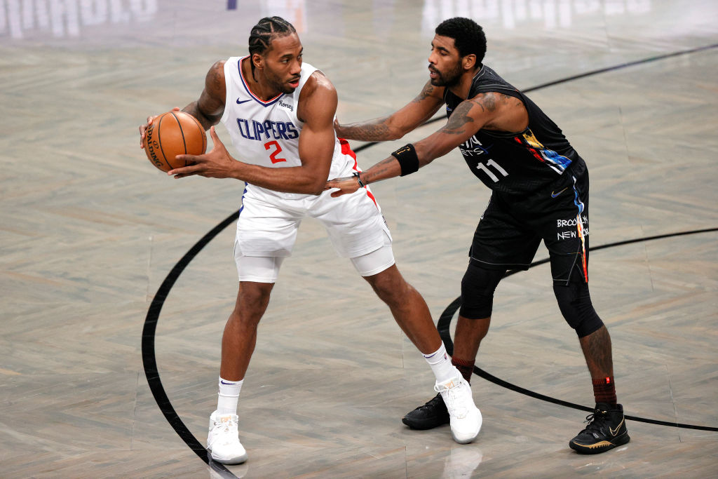 NEW YORK, NEW YORK - FEBRUARY 02: Kawhi Leonard #2 of the LA Clippers dribbles against Kyrie Irving #11 of the Brooklyn Nets during the first half at Barclays Center on February 02, 2021 in the Brooklyn borough of New York City. NOTE TO USER: User expressly acknowledges and agrees that, by downloading and or using this Photograph, user is consenting to the terms and conditions of the Getty Images License Agreement. (Photo by Sarah Stier/Getty Images)