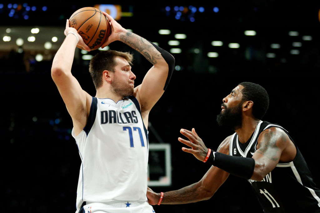 NEW YORK, NEW YORK - OCTOBER 27: Luka Doncic #77 of the Dallas Mavericks looks to pass as Kyrie Irving #11 of the Brooklyn Nets defends during the second half at Barclays Center on October 27, 2022 in the Brooklyn borough of New York City. The Mavericks won 129-125. NOTE TO USER: User expressly acknowledges and agrees that, by downloading and or using this photograph, User is consenting to the terms and conditions of the Getty Images License Agreement. (Photo by Sarah Stier/Getty Images)