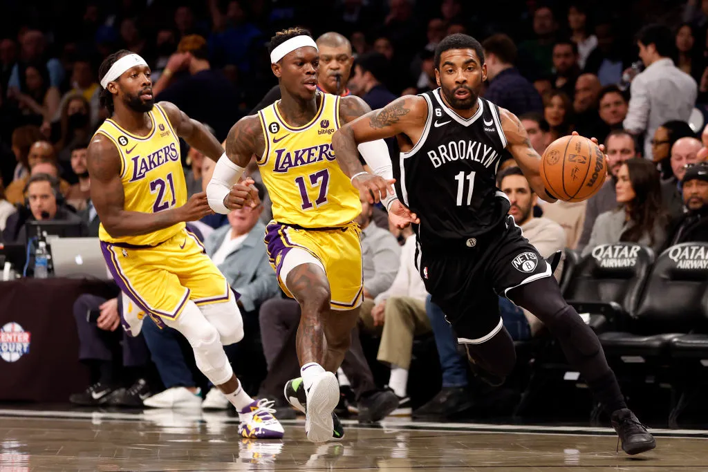 NEW YORK, NEW YORK - JANUARY 30: Kyrie Irving #11 of the Brooklyn Nets dribbles as Patrick Beverley #21 and Dennis Schroder #17 of the Los Angeles Lakers defend during the second half at Barclays Center on January 30, 2023 in the Brooklyn borough of New York City. The Nets won 121-104. NOTE TO USER: User expressly acknowledges and agrees that, by downloading and/or using this photograph, User is consenting to the terms and conditions of the Getty Images License Agreement. (Photo by Sarah Stier/Getty Images)
