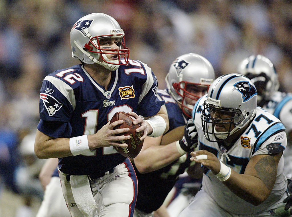 HOUSTON, TX - FEBRUARY 1: Quarterback Tom Brady #12 of the New England Patriots with the ball against the Carolina Panthers during Super Bowl XXXVIII at Reliant Stadium on February 1, 2004 in Houston, Texas. The Patriots won 32-29 to claim their second Super Bowl in three years. (Photo by Donald Miralle/Getty Images)