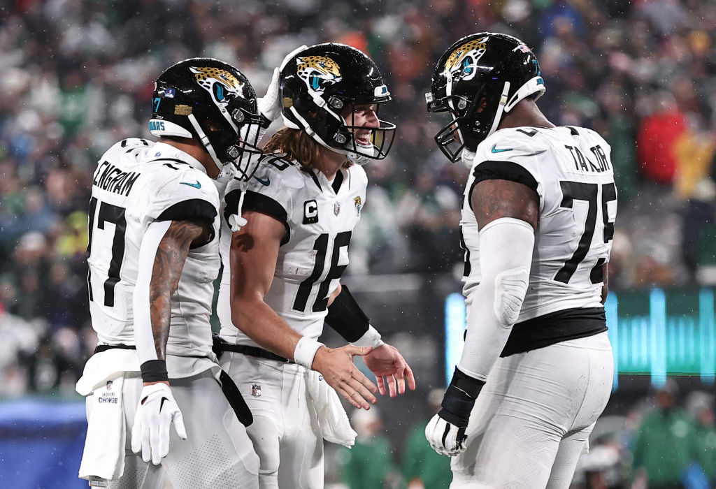 EAST RUTHERFORD, NEW JERSEY - DECEMBER 22: Trevor Lawrence #16 of the Jacksonville Jaguars celebrates with Evan Engram #17 and Jawaan Taylor #75 after a touchdown during the 1st half of the game at MetLife Stadium on December 22, 2022 in East Rutherford, New Jersey. (Photo by Dustin Satloff/Getty Images)