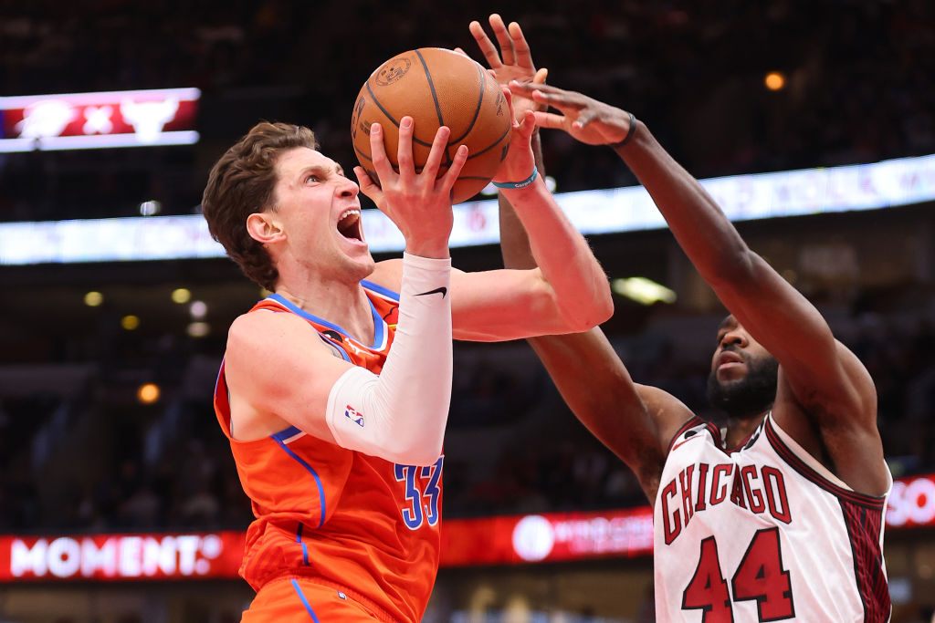 CHICAGO, ILLINOIS - JANUARY 13: Mike Muscala #33 of the Oklahoma City Thunder shoots over Patrick Williams #44 of the Chicago Bulls during the second half at United Center on January 13, 2023 in Chicago, Illinois. (Photo by Michael Reaves/Getty Images)