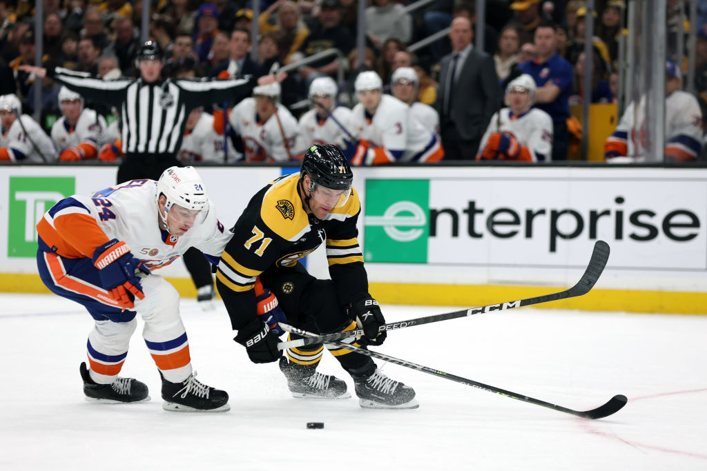 BOSTON, MASSACHUSETTS - FEBRUARY 18: Scott Mayfield #24 of the New York Islanders defends Taylor Hall #71 of the Boston Bruins during the first period at TD Garden on February 18, 2023 in Boston, Massachusetts. (Photo by Maddie Meyer/Getty Images)