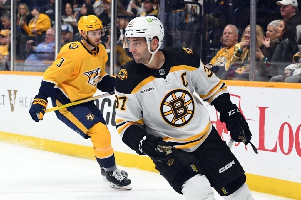 Feb 16, 2023; Nashville, Tennessee, USA; Boston Bruins center Patrice Bergeron (37) reacts after a goal during the second period against the Nashville Predators at Bridgestone Arena. Mandatory Credit: Christopher Hanewinckel/USA TODAY Sports