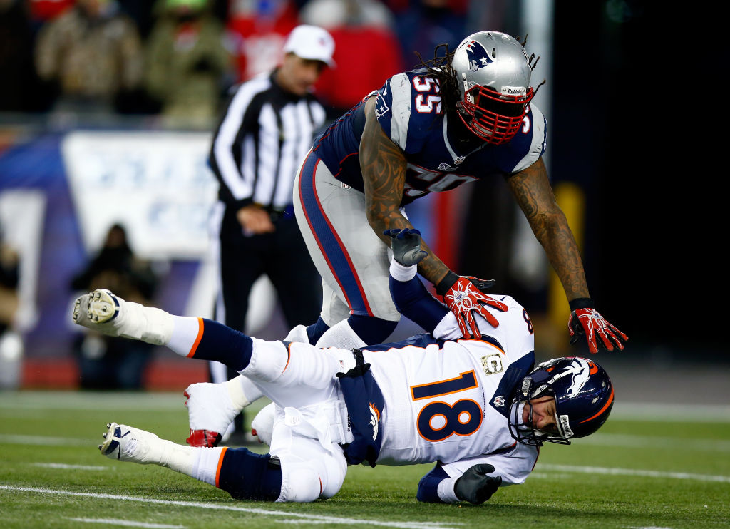 FOXBORO, MA - NOVEMBER 24: Middle linebacker Brandon Spikes #55 of the New England Patriots tackles quarterback Peyton Manning #18 of the Denver Broncos during a game at Gillette Stadium on November 24, 2013 in Foxboro, Massachusetts. (Photo by Jared Wickerham/Getty Images)