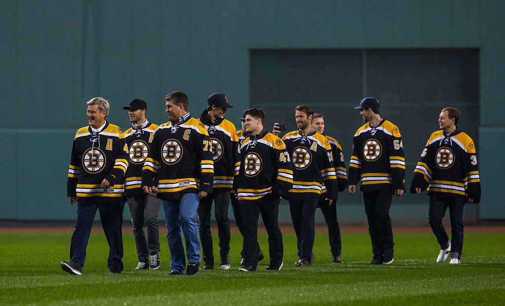 BOSTON, MA - OCTOBER 1: Current and past Boston Bruins hockey players Bobby Orr, Ray Bourque, Torey Krug, David Krejci and Tuukka Rask walk across the outfield during pregame ceremonies honoring David Ortiz #34 of the Boston Red Sox at Fenway Park on October 1, 2016 in Boston, Massachusetts. The Blue Jays won 4-3. (Photo by Rich Gagnon/Getty Images)