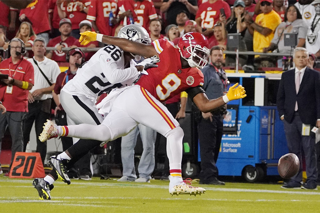 Oct 10, 2022; Kansas City, Missouri, USA; Las Vegas Raiders cornerback Rock Ya-Sin (26) barks up a pass intended for Kansas City Chiefs wide receiver JuJu Smith-Schuster (9) in the first quarter at GEHA Field at Arrowhead Stadium. Mandatory Credit: ​Denny Medley-USA TODAY Sports