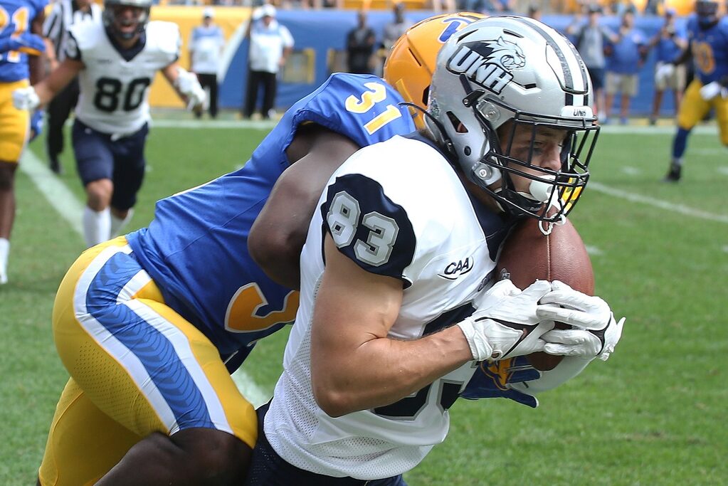 Sep 25, 2021; Pittsburgh, Pennsylvania, USA; New Hampshire Wildcats wide receiver Sean Coyne (83) scores a touchdown against Pittsburgh Panthers defensive back Erick Hallett (31) during the second quarter at Heinz Field. Credit: Charles LeClaire-USA TODAY Sports