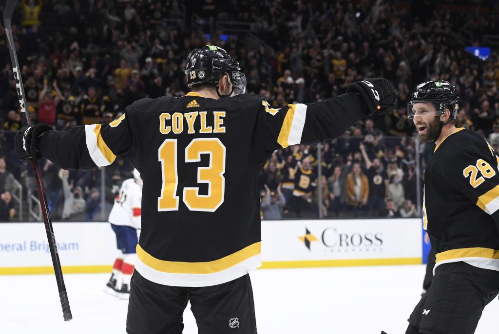 Oct 30, 2021; Boston, Massachusetts, USA; Boston Bruins center Charlie Coyle (13) reacts with defenseman Derek Forbort (28) after scoring a goal during the first period against the Florida Panthers at TD Garden. Mandatory Credit: Bob DeChiara-USA TODAY Sports