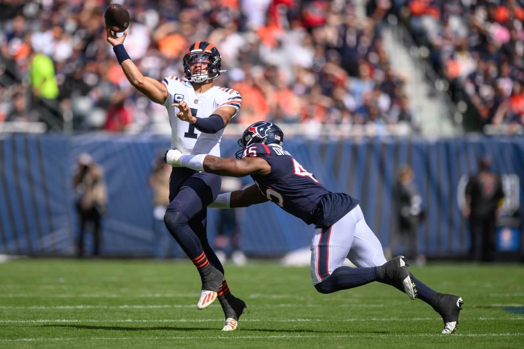 Sep 25, 2022; Chicago, Illinois, USA; Chicago Bears quarterback Justin Fields (1) passes the ball as Houston Texans defensive end Obo Okoronkwo (45) pressures in the first quarter at Soldier Field. Credit: Daniel Bartel-USA TODAY Sports